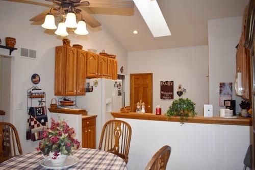 25109 Indian Ridge Road Sterling, IL 61081 - Photo 19 of 34 a view of a dining room with furniture a chandelier and a large window
