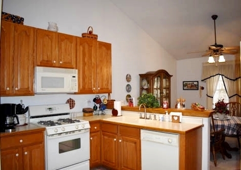 25109 Indian Ridge Road Sterling, IL 61081 - Photo 20 of 34 a kitchen with a sink stove and cabinets