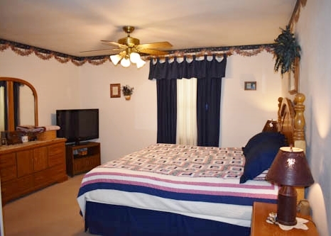 25109 Indian Ridge Road Sterling, IL 61081 - Photo 25 of 34 a bedroom with a bed and a television