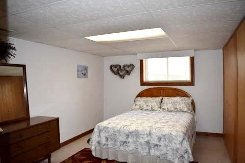 25109 Indian Ridge Road Sterling, IL 61081 - Photo 31 of 34 a bedroom with a bed and a window