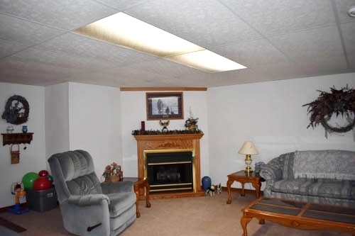 25109 Indian Ridge Road Sterling, IL 61081 - Photo 33 of 34 a living room with furniture and a fireplace