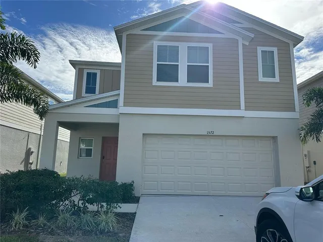 a front view of a house with garage