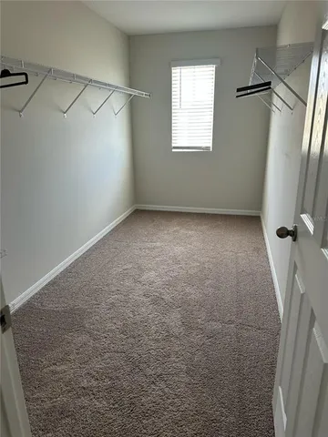 a view of a room with an empty space and a window