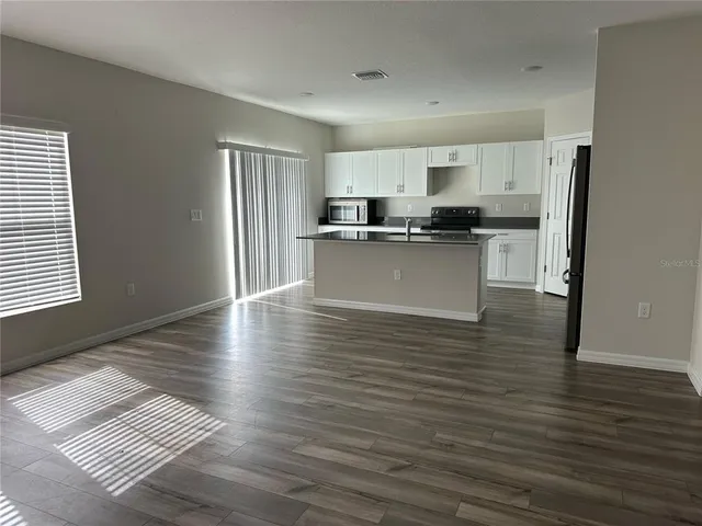 a kitchen with stainless steel appliances granite countertop a refrigerator and a stove