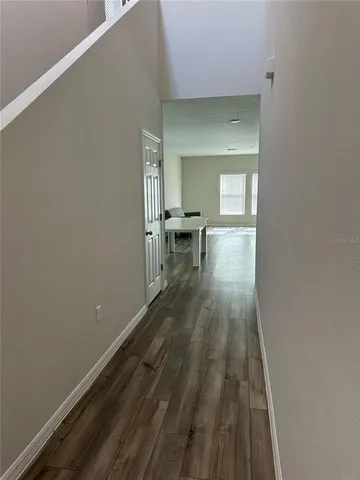 a view of a room with wooden floor and bench