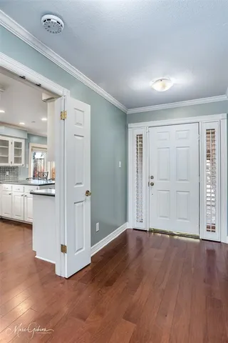 a kitchen with granite countertop cabinets and wooden floor