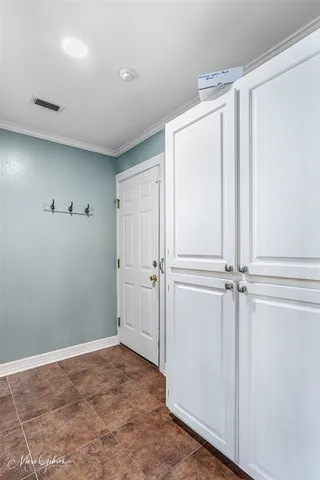 a view of a kitchen with wooden floor and cabinets