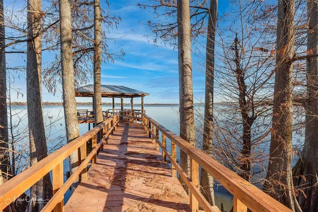 a view of balcony with wooden floor and fence