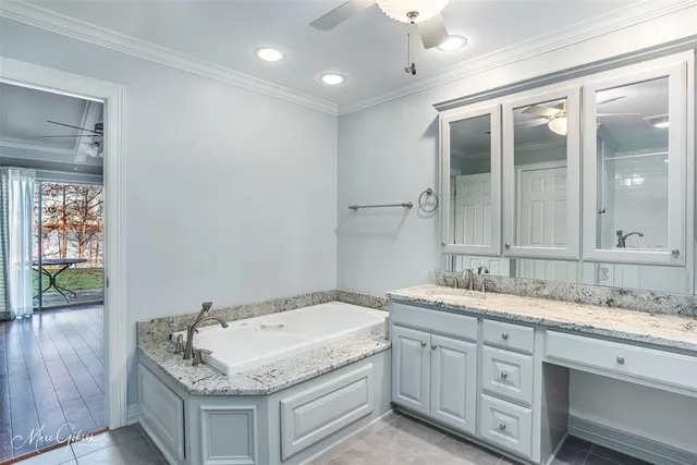 a bathroom with a granite countertop sink a large mirror and shower
