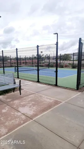 a view of a patio with a table and chairs under an umbrella