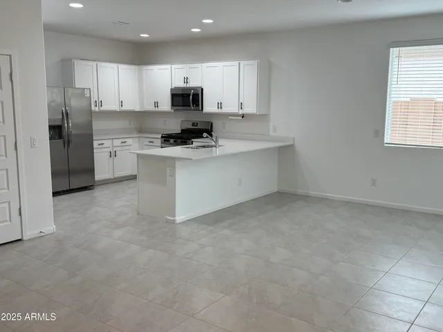 a kitchen with cabinets and appliances
