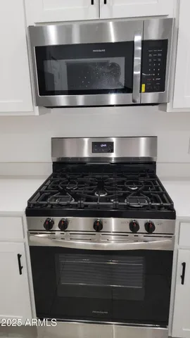 a stove top oven sitting inside of a kitchen