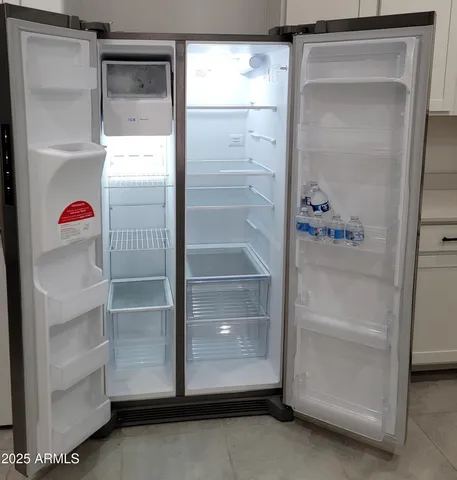 an empty room with closet and windows