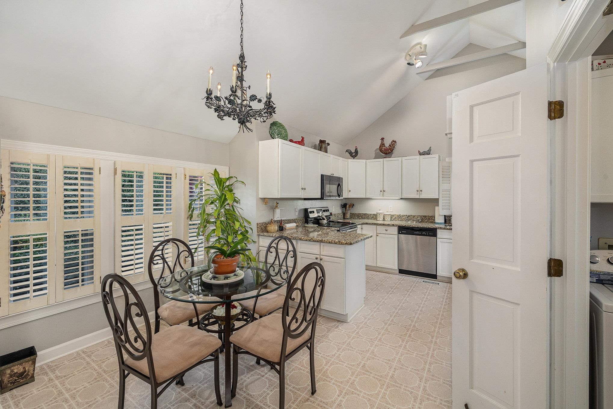 1829 Falls Church Road Raleigh, NC 27609 - Photo 9 of 30 a view of a dining room with furniture window and wooden floor