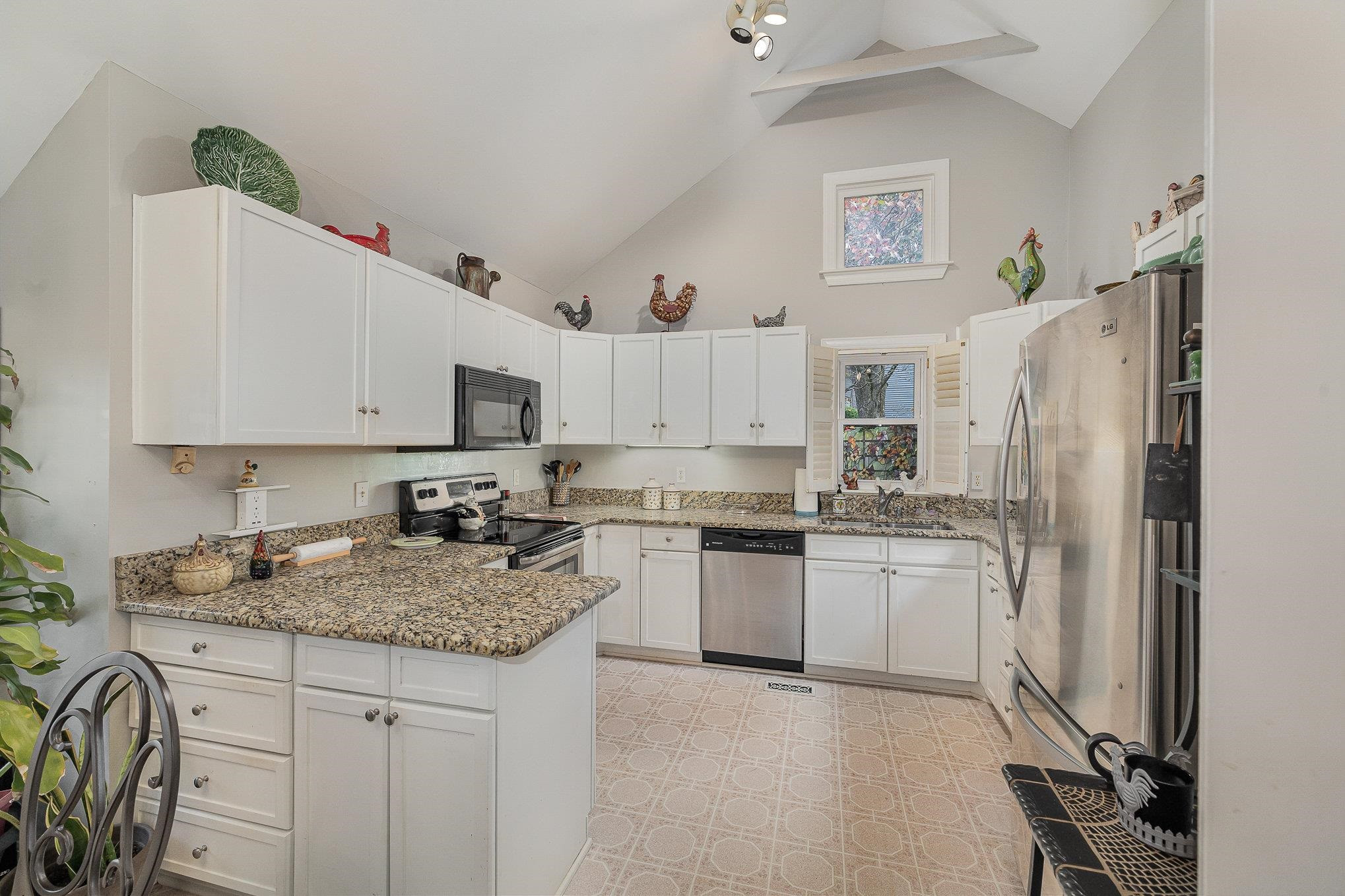 1829 Falls Church Road Raleigh, NC 27609 - Photo 10 of 30 a kitchen with stainless steel appliances granite countertop a sink stove and refrigerator