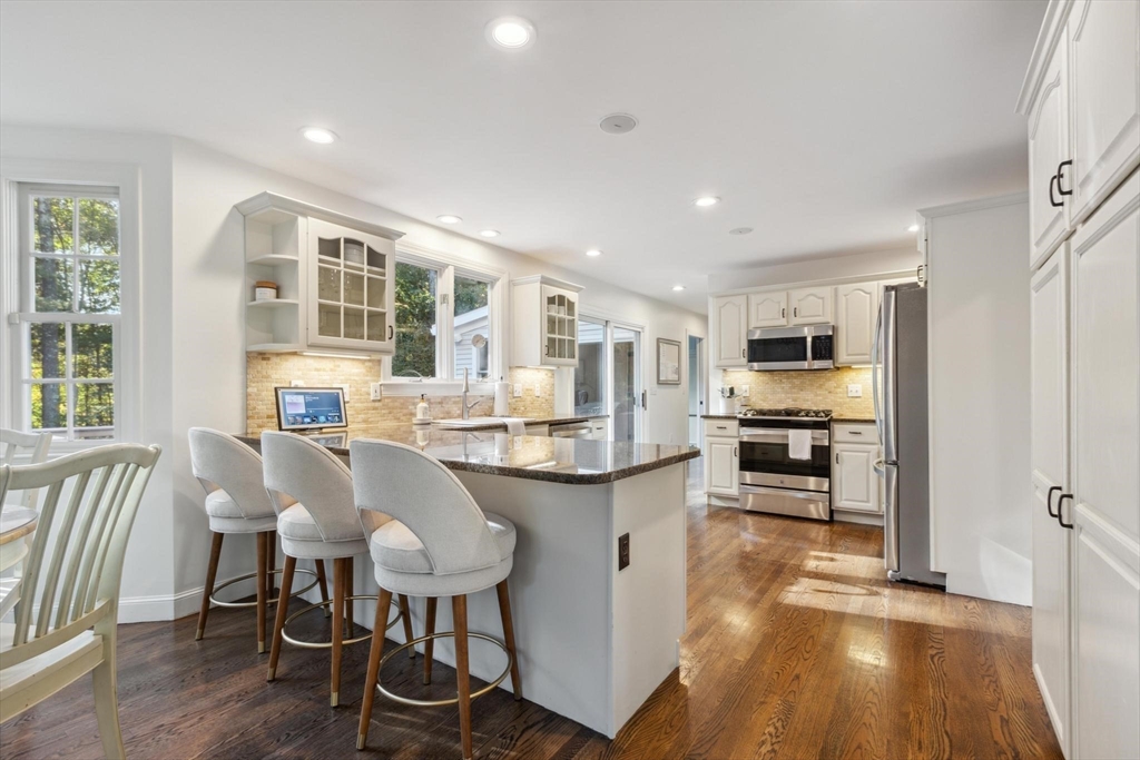 8 MacIntyre Drive North Reading, MA 01864 - Photo 12 of 42 a living room with stainless steel appliances kitchen island granite countertop furniture and wooden floor