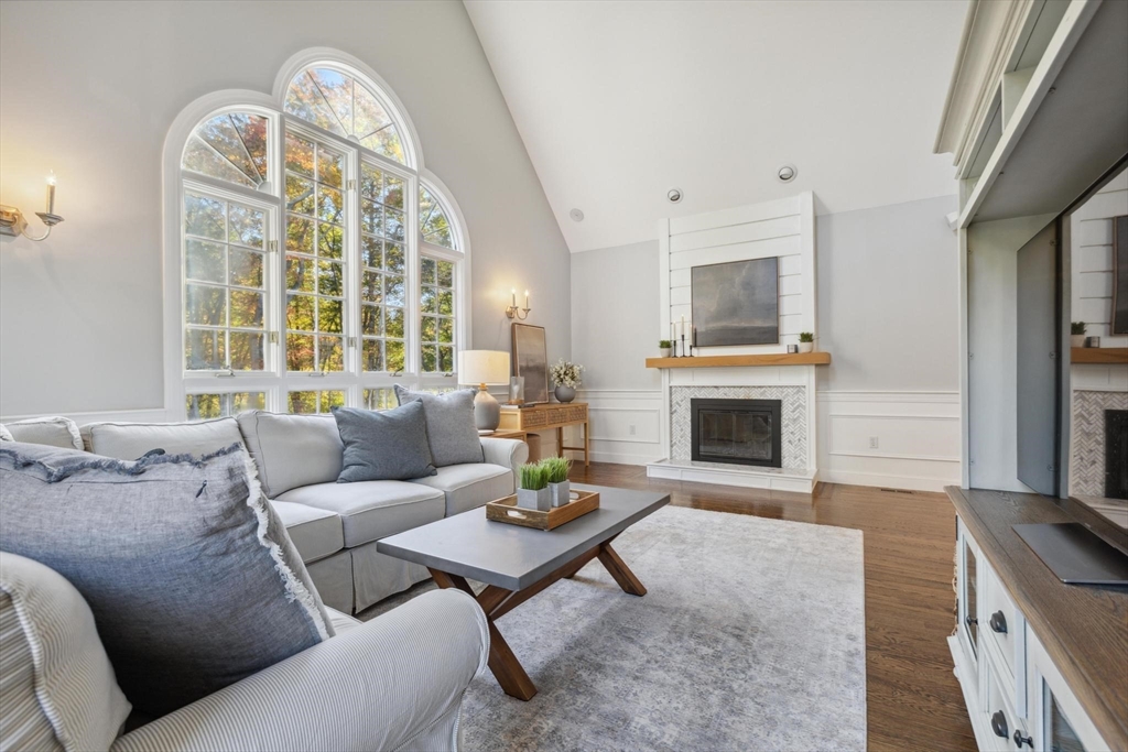 8 MacIntyre Drive North Reading, MA 01864 - Photo 17 of 42 a living room with furniture a fireplace and a large window