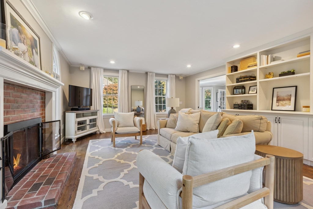 8 MacIntyre Drive North Reading, MA 01864 - Photo 21 of 42 a living room with furniture a flat screen tv and a fireplace