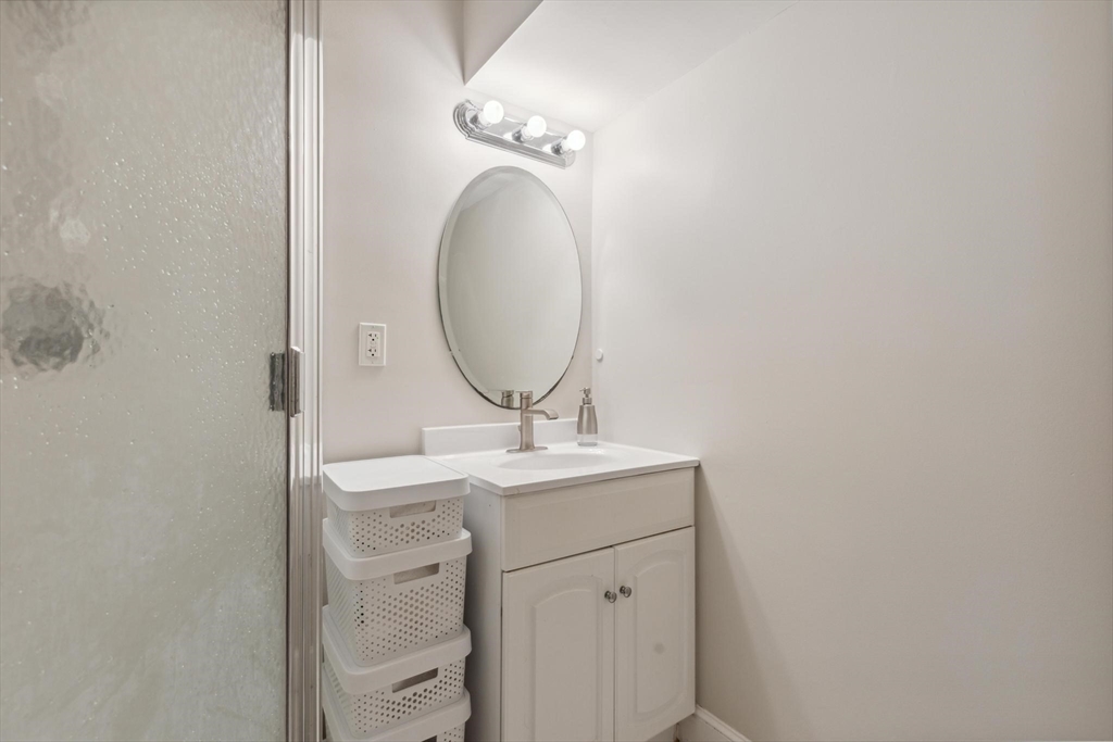 8 MacIntyre Drive North Reading, MA 01864 - Photo 38 of 42 a bathroom with a sink a light fixture and a mirror