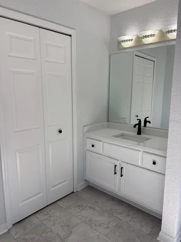 a bathroom with a double vanity sink and mirror