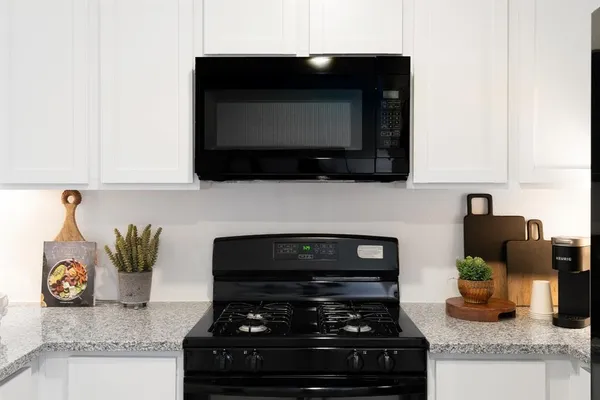 a kitchen with sink a counter top space and appliances