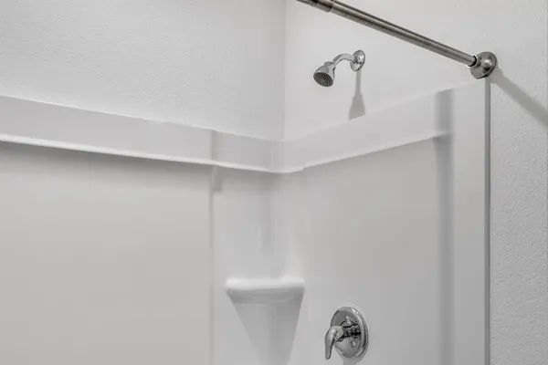 a bathroom with a granite countertop sink toilet a mirror and shower