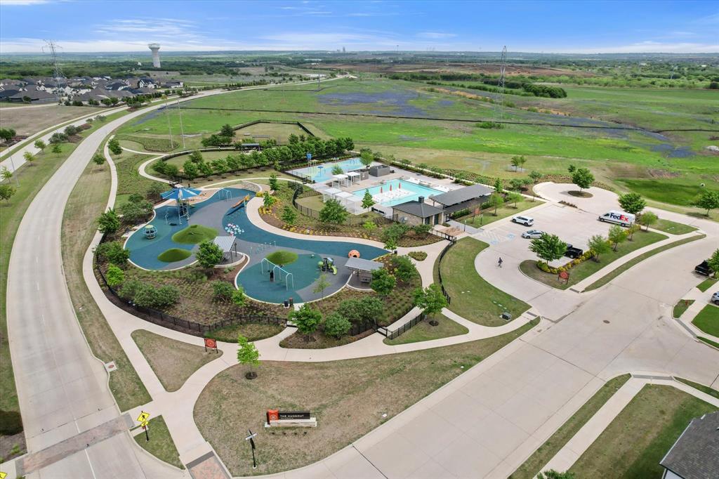 6910 Prairieside Trail Venus, TX 76084 - Photo 40 of 40 Aerial view of the community amenities, featuring a swimming pool, splash pad, and playground
