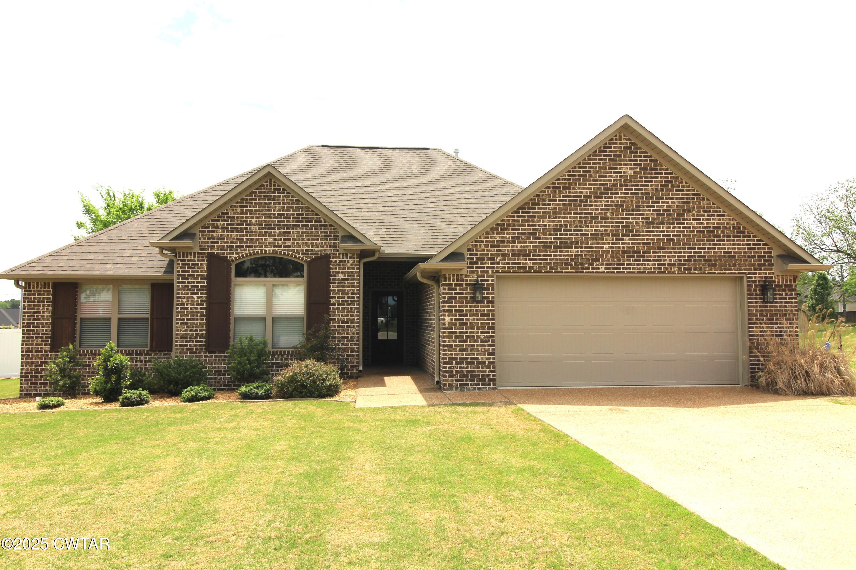 6151 Windsor Drive Milan, TN 38358 - Photo 1 of 25 a front view of a house with a yard