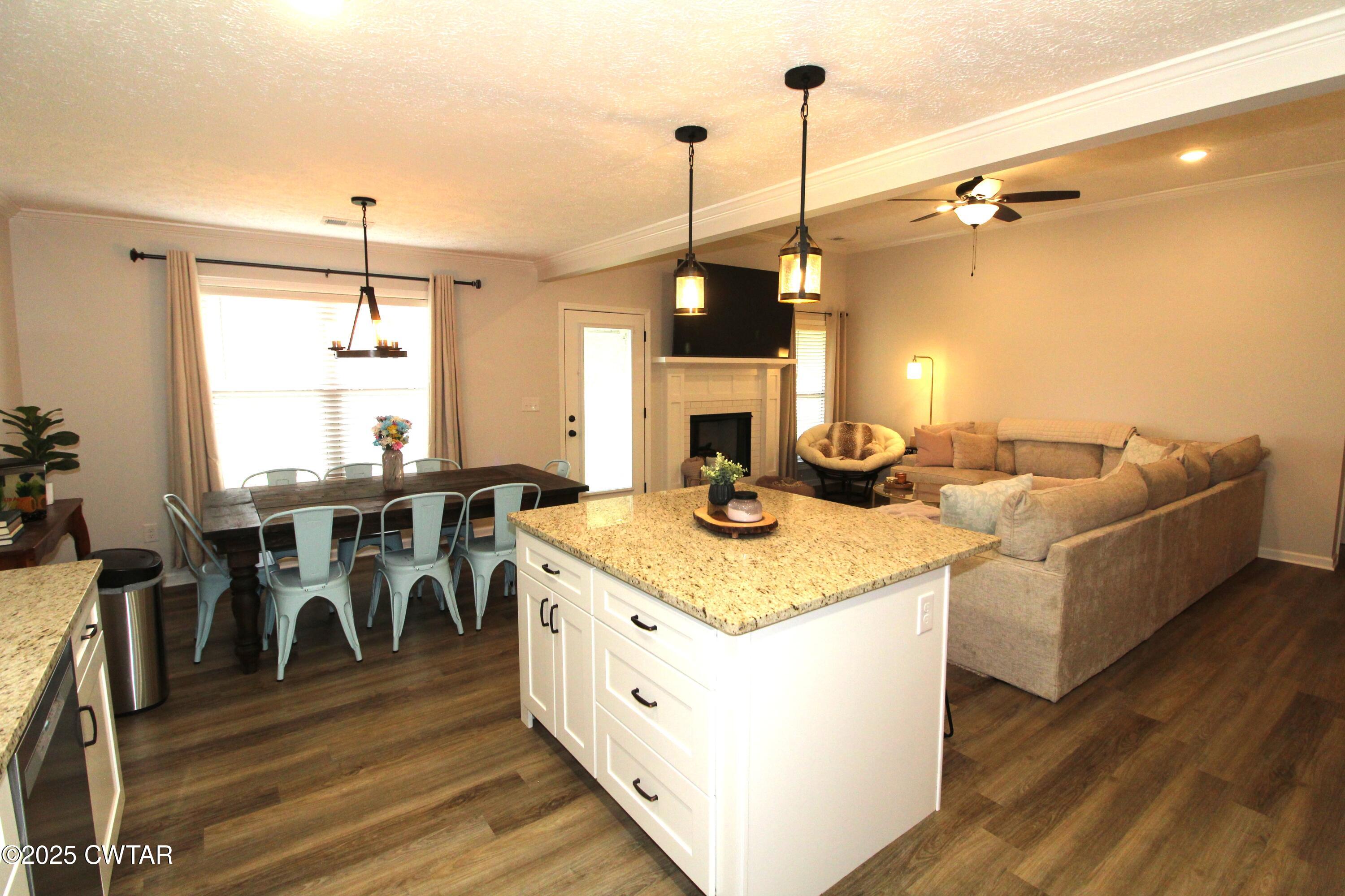 6151 Windsor Drive Milan, TN 38358 - Photo 13 of 25 a kitchen with a stove and a table with chairs