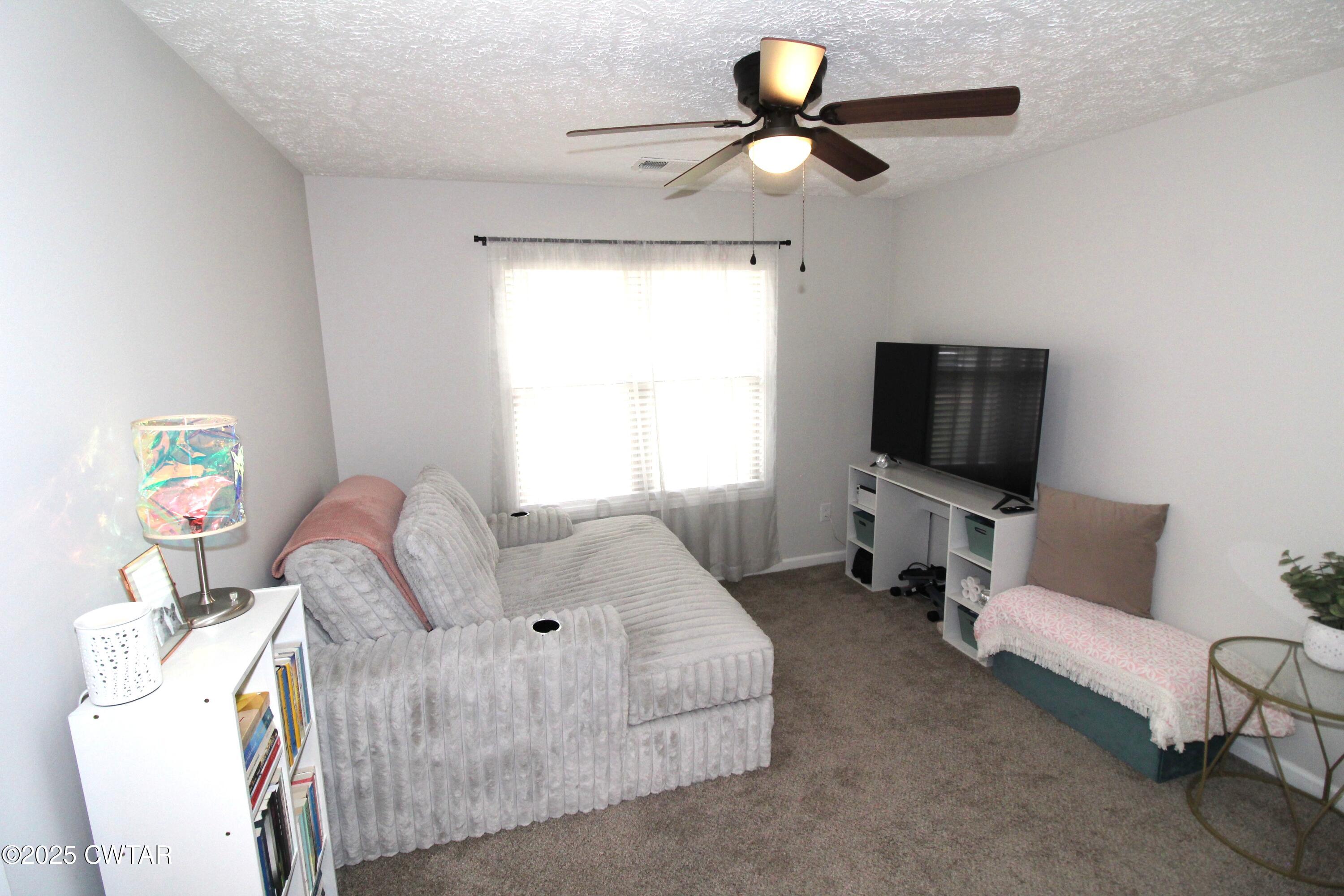 6151 Windsor Drive Milan, TN 38358 - Photo 20 of 25 a living room with furniture and a flat screen tv