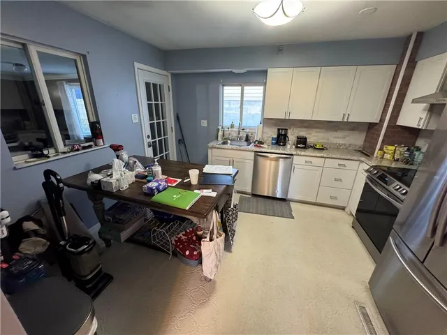 a kitchen with a sink appliances and cabinets