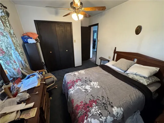 a bedroom with bed and a window