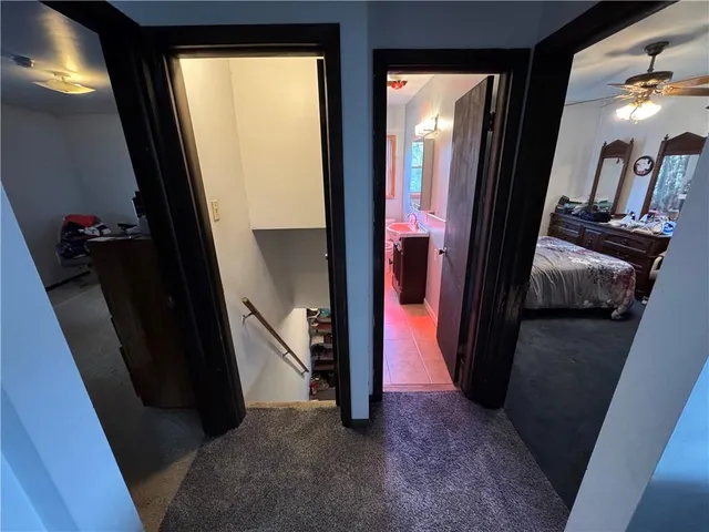 a view of a hallway and a livingroom with furniture