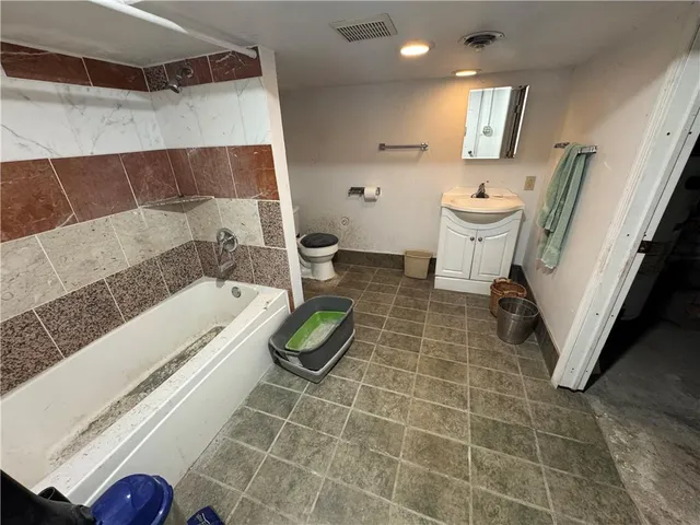 a bathroom with a sink a toilet and bathtub