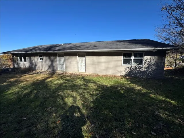 a view of house with backyard