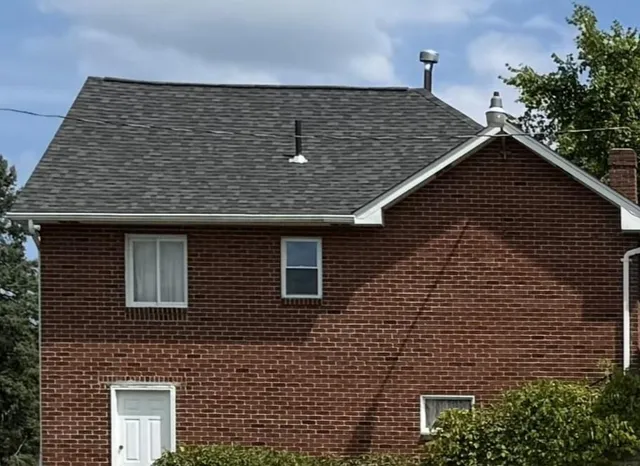 a front view of a house with plants