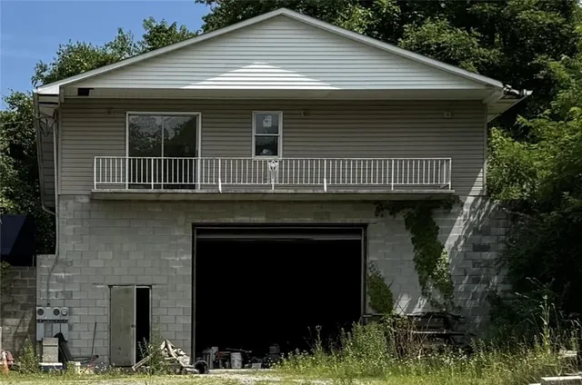 a view of a yard with wooden fence
