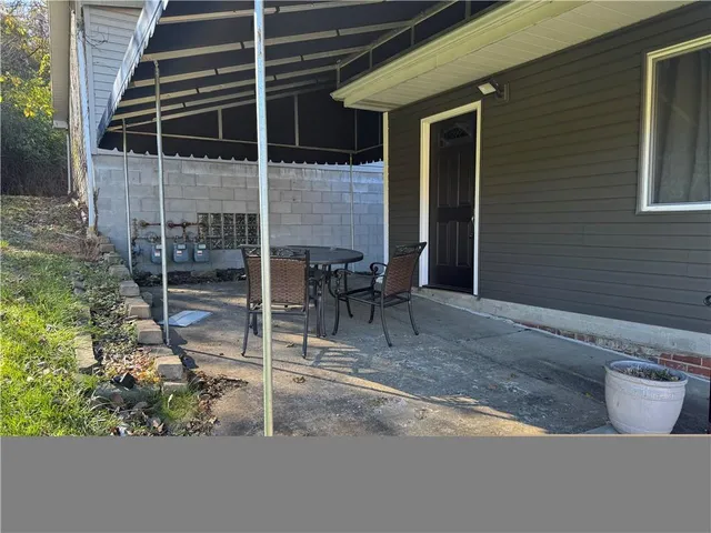 a backyard of a house with table and chairs