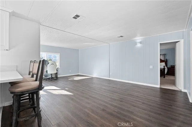 a view of a livingroom with furniture and a gym equipment