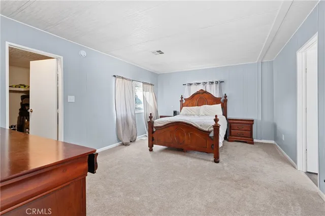 a bedroom with a bed and a table in it