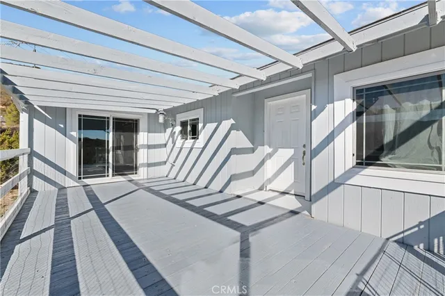 a view of balcony with two chairs and wooden floor