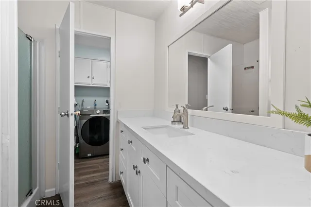 a bathroom with a sink a washer and dryer