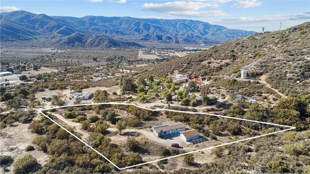 an aerial view of house with mountain view