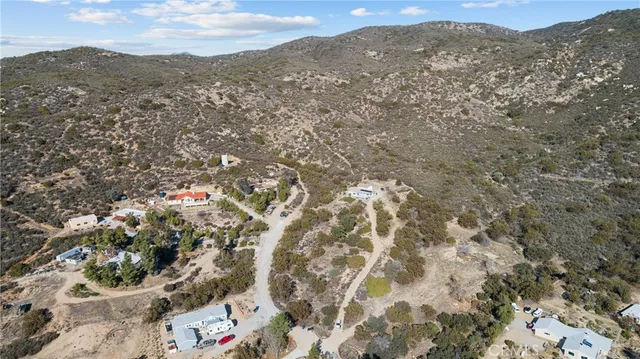 an aerial view of a house with a mountain