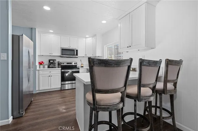 a view of kitchen with cabinets and wooden floor