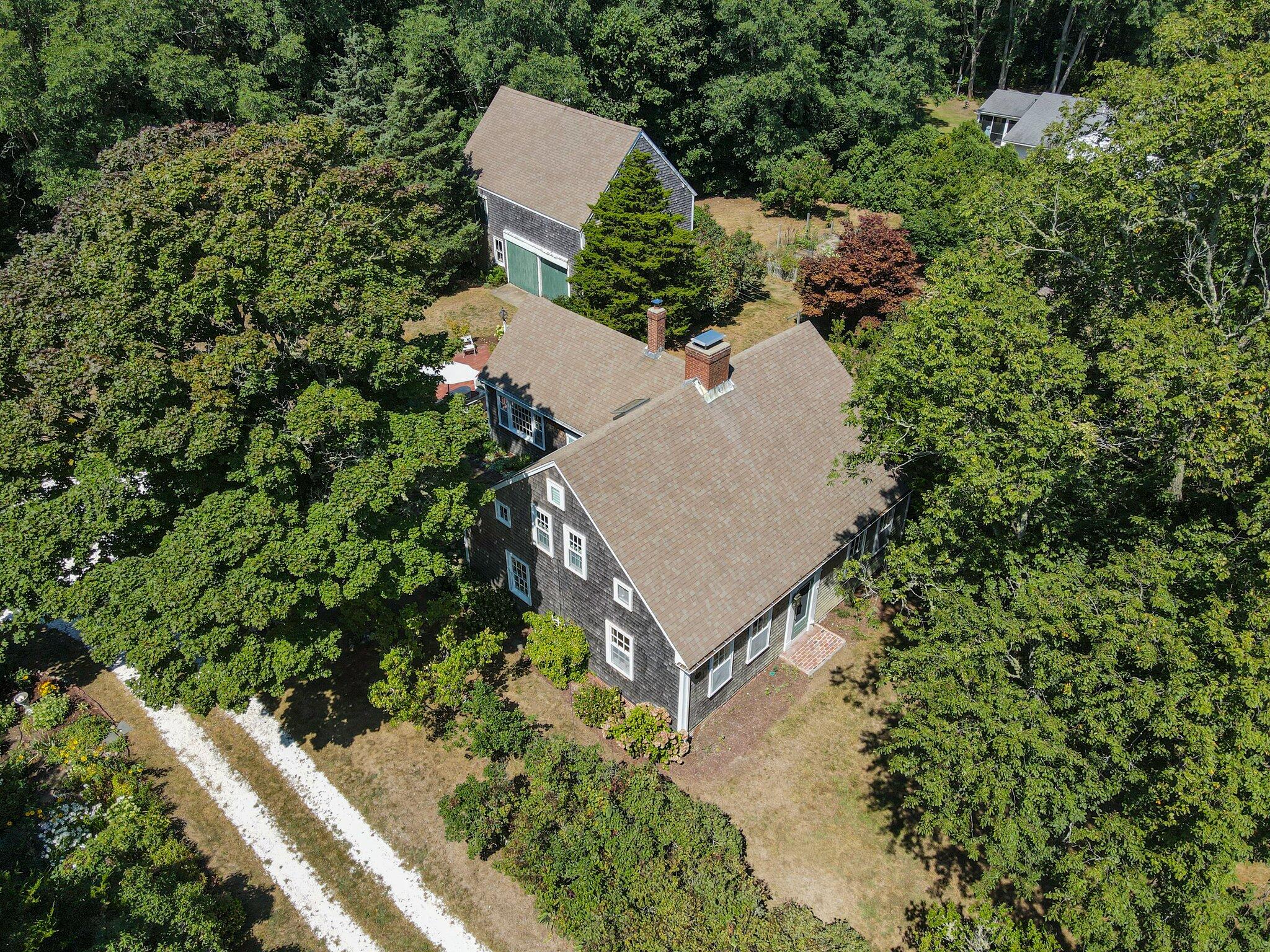 1955 Bridge Road Eastham, MA 02642 - Photo 1 of 77 an aerial view of a house with a yard and trees in the back