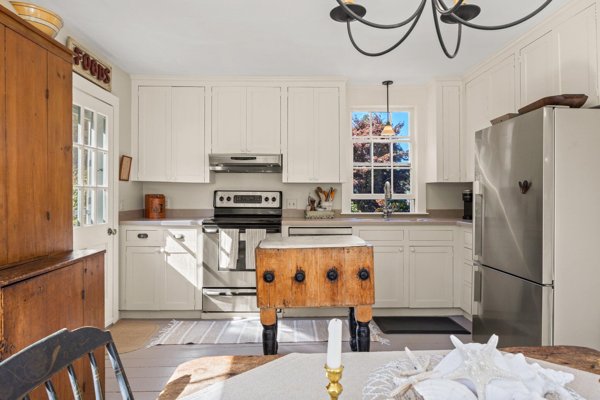 1955 Bridge Road Eastham, MA 02642 - Photo 22 of 77 a kitchen with stainless steel appliances kitchen island granite countertop a refrigerator and a stove top oven