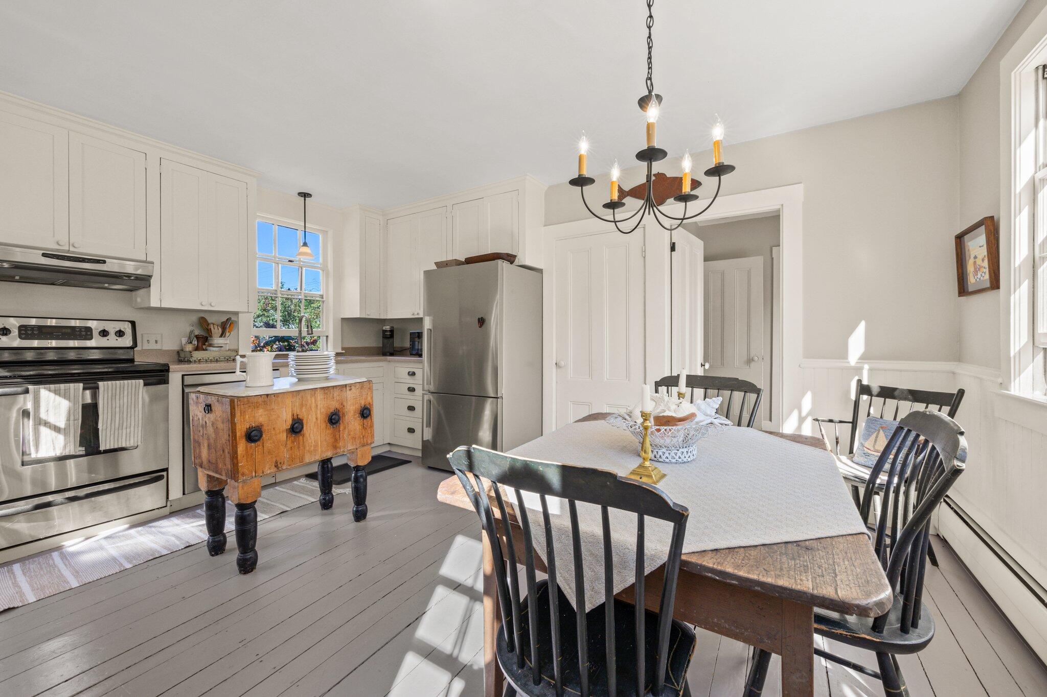 1955 Bridge Road Eastham, MA 02642 - Photo 23 of 77 a view of a dining room with furniture a chandelier and wooden floor