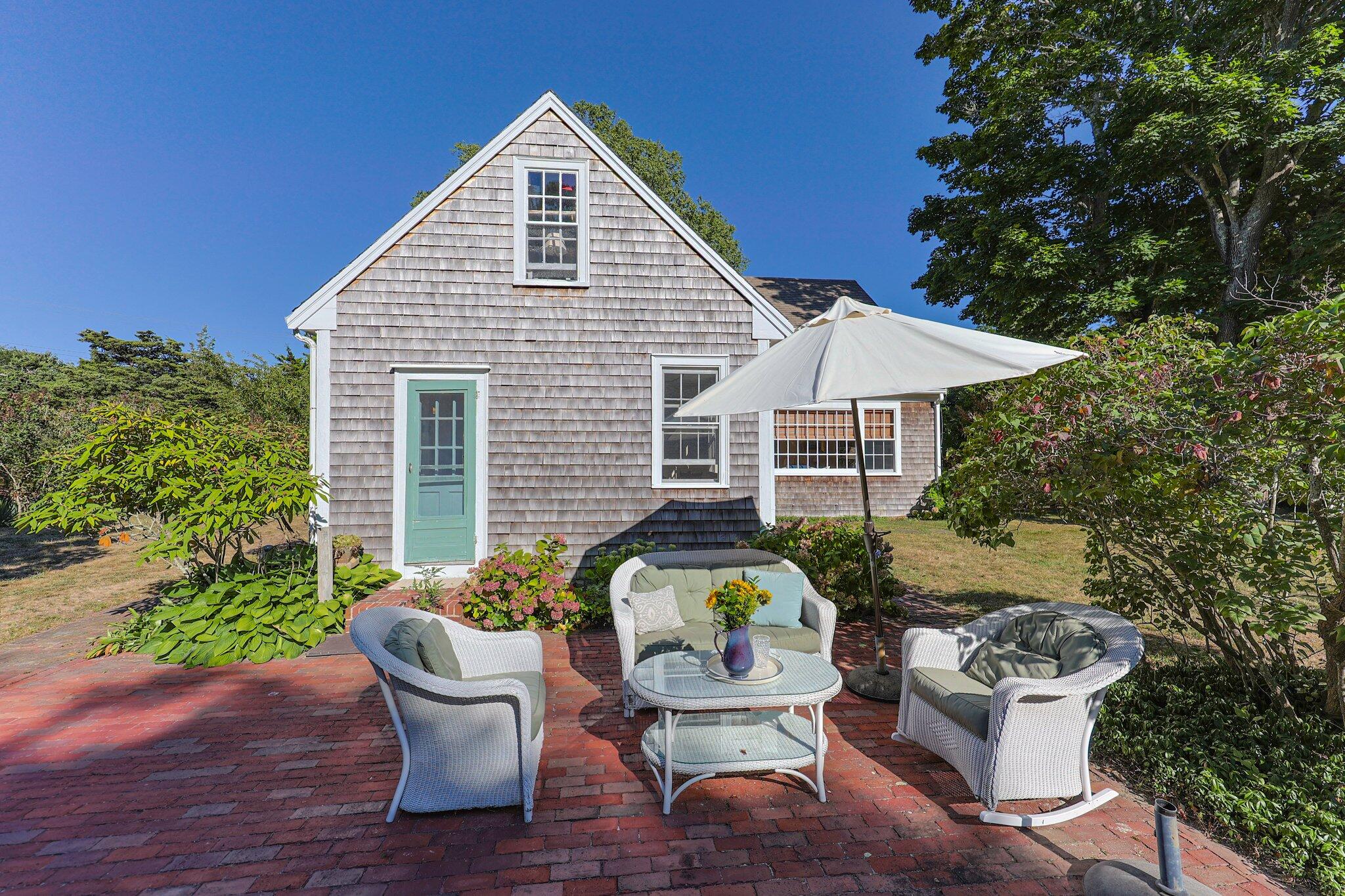 1955 Bridge Road Eastham, MA 02642 - Photo 35 of 77 a view of a house with a chairs and table in a patio