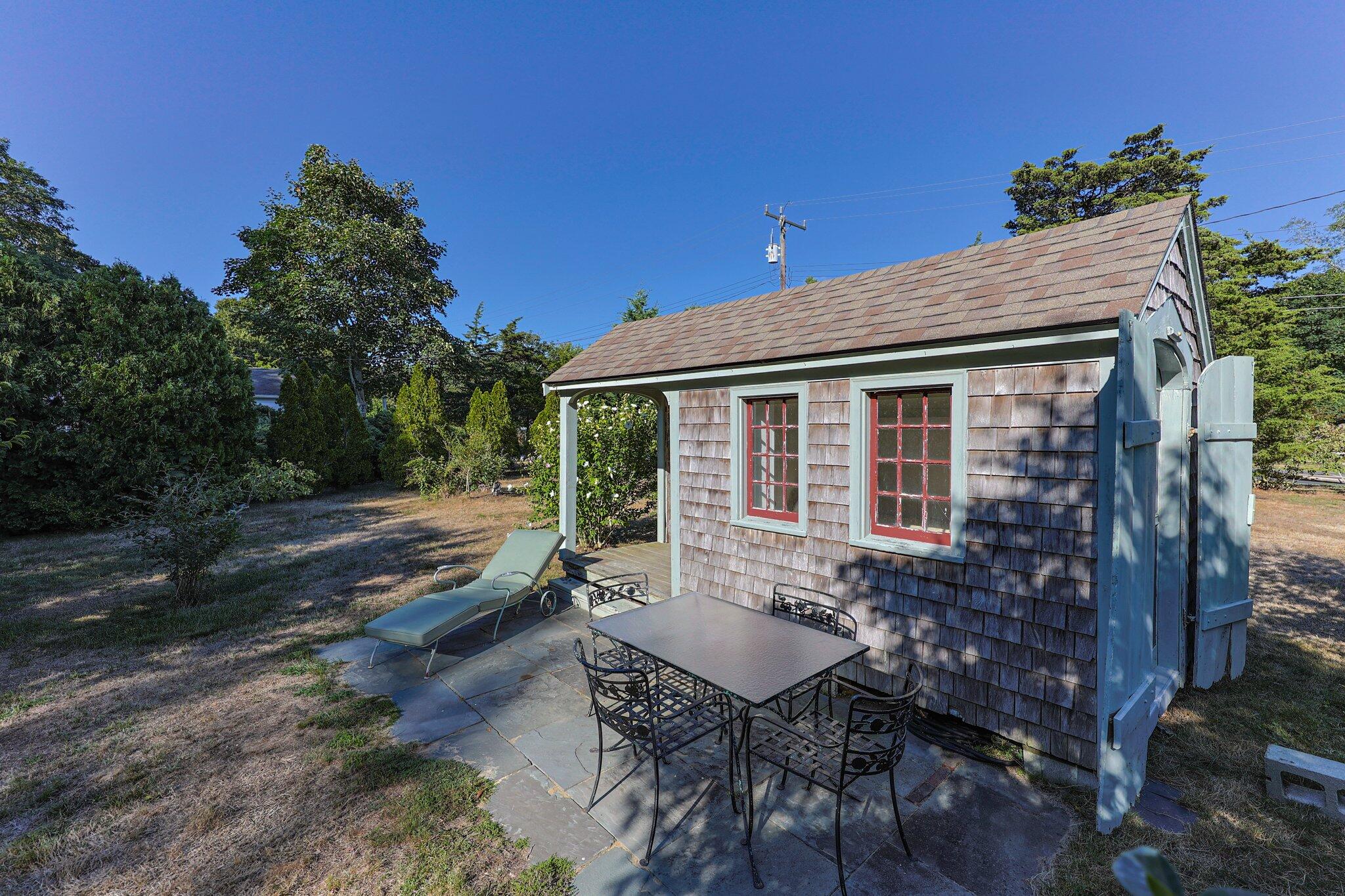 1955 Bridge Road Eastham, MA 02642 - Photo 43 of 77 a backyard of a house with table and chairs